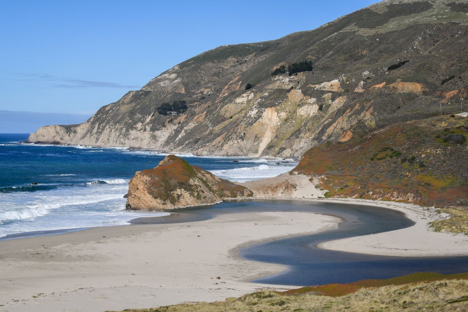 A river meeting the Pacific on the Northern California coast