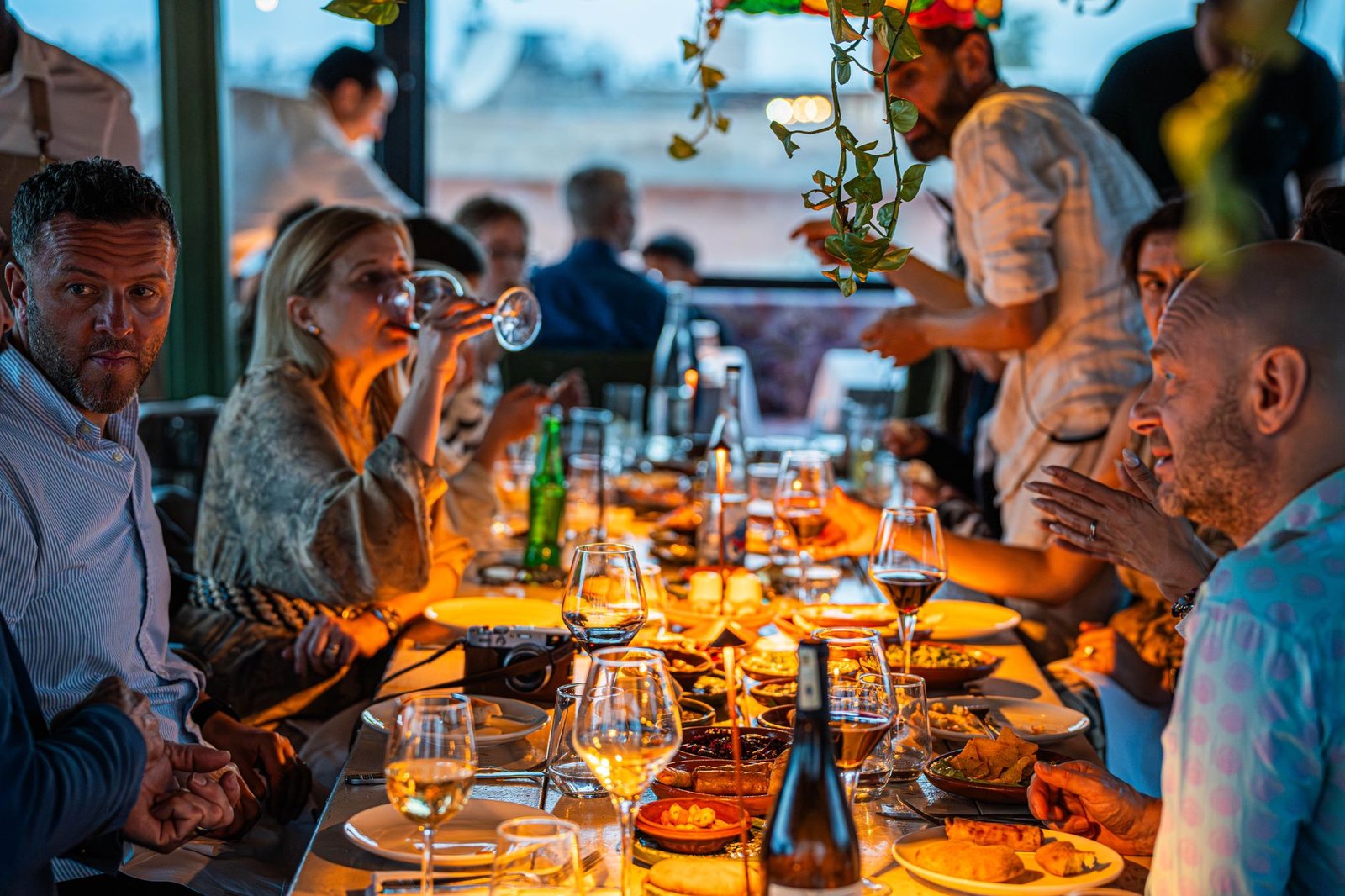 Friends at a long table in the evening