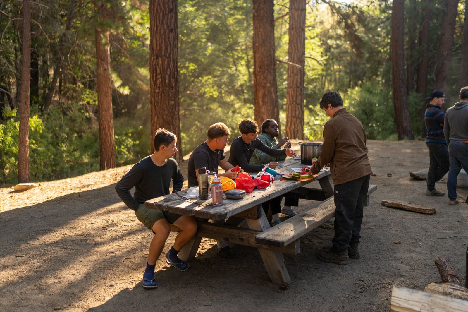 A group sharing a meal outdoors